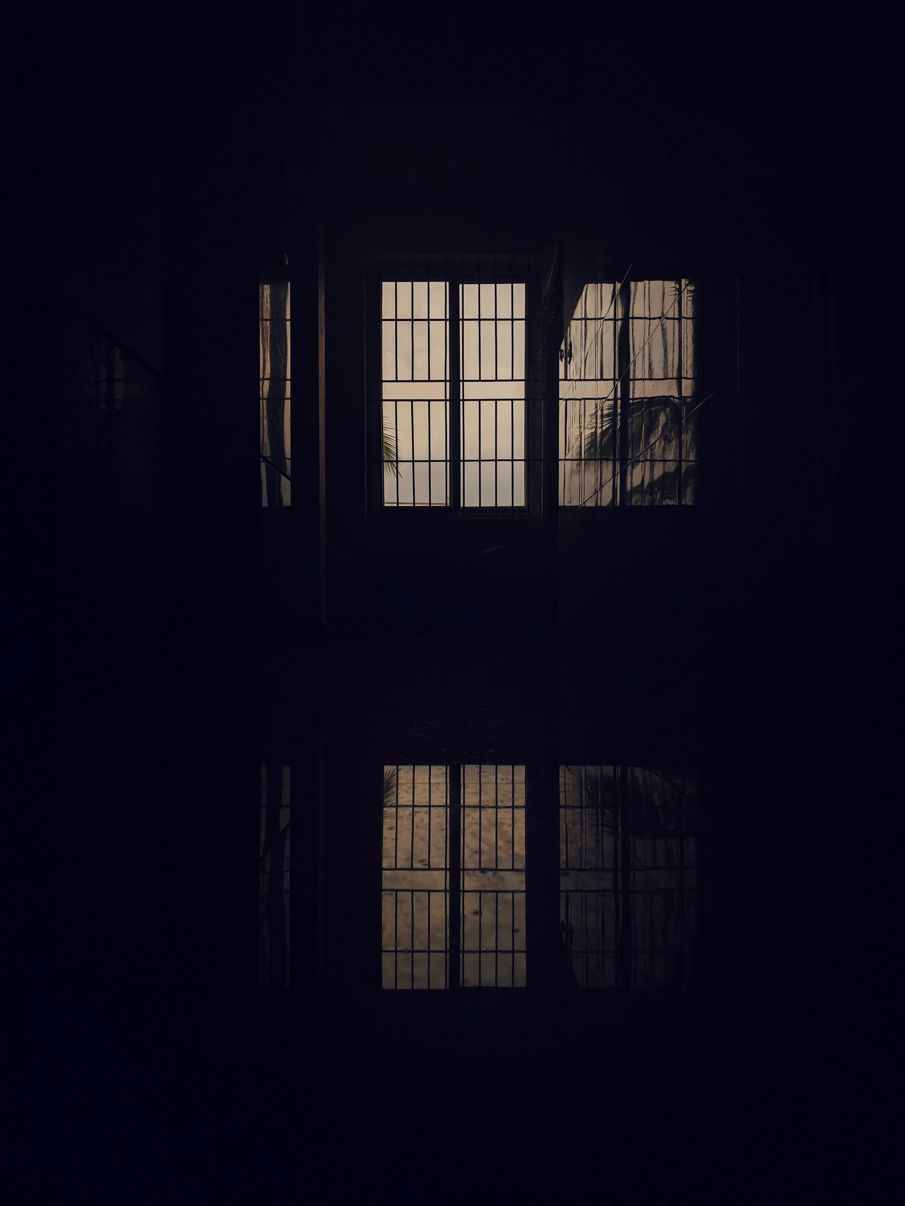 A window that being reflected on adjacscent tiles and floors in the evening sunlight